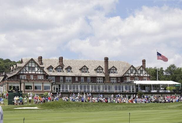 Fans sit in front of the club house to watch the players come to the 18th green in a practice round at the PGA Golf Herren Championship at Baltusrol Golf Club in Springfield, New Jersey on July 26, 2016.  PGA20160726112 JOHNxANGELILLO