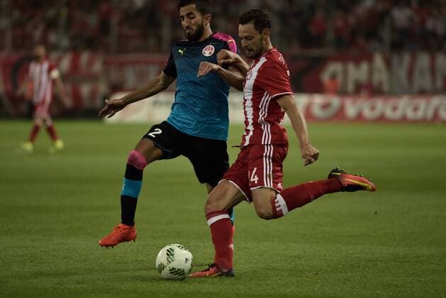 Greece: Olympiacos vs Hapoel Beer-Sheva (0-0) Alberto De La Bella (no 24) of Olympiacos tries to pass the ball by avoiding Ben Bitton (no 2) of Hapoel Beer-Sheva.  DimitriosxKarvountzis PacificxPress