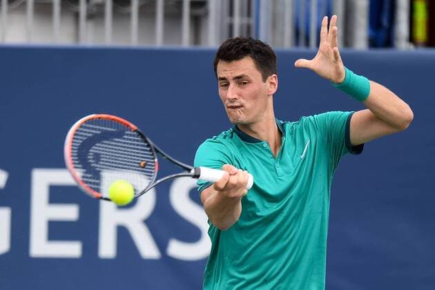 July 28, 2016: Bernard Tomic of Australiareturns the ball to Kevin Anderson of South Africa during their third round match of the Rogers Cup tournament at the Aviva Centre in Toronto, Ontario, Canada on July 28, 2016. Cal Media TENNIS 2016 - Rogers Cup Toronto July 28 - ZUMAc04_