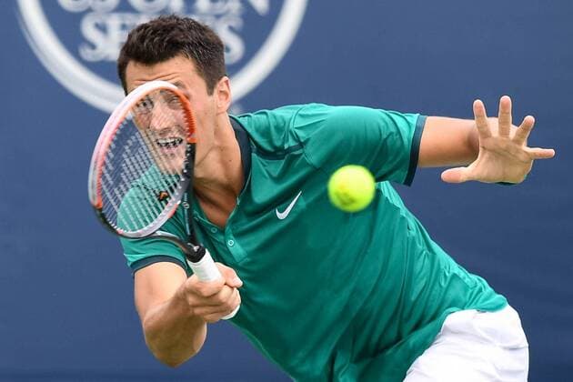 July 28, 2016: Bernard Tomic of Australia returns the ball to Kevin Anderson of South Africa during their third round match of the Rogers Cup tournament at the Aviva Centre in Toronto, Ontario, Canada on July 28, 2016. Cal Media TENNIS 2016 - Rogers Cup Toronto July 28 - ZUMAc04_