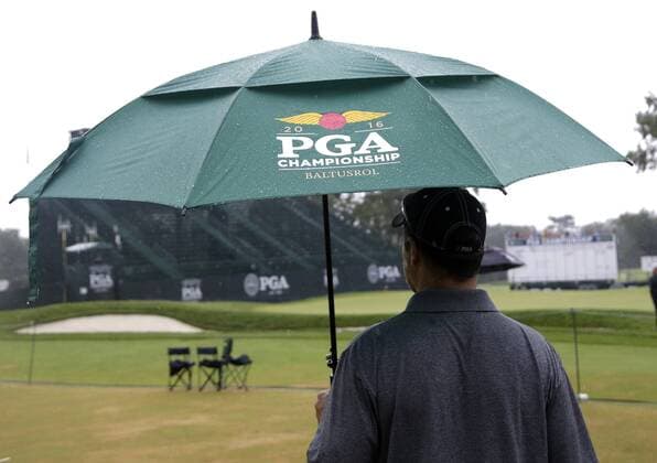 Bilder des Tages - SPORT Patrons walk the golf course carrying umbrellas in the rain before play is suspended due to rain in the 3rd round at the PGA Golf Herren Championship at Baltusrol Golf Club in Springfield, New Jersey on July 30, 2016.  PGA20160730116 JOHNxANGELILLO