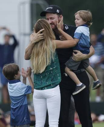 Jimmy Walker celebrates on the 18th green with his wife Erin and children Mclain and Beckett after the final round at the PGA Golf Herren Championship at Baltusrol Golf Club in Springfield, New Jersey on July 31, 2016. Walker won the championship and his first major with a score of 14 under par.  PGA20160731133 JOHNxANGELILLO