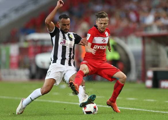 MOSCOW, RUSSIA - AUGUST 4, 2016: AEK Larnaka s Juanma Ortiz (17, left), and Spartak Moscow s Dmitry Kombarov (23) in their 2016 2017 UEFA Europa League Third Qualifying Round football match at Otkrytie Arena. Artyom Korotayev TASS  TS02BD18