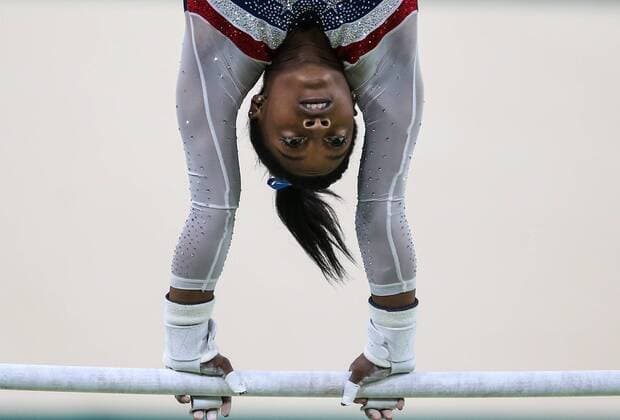 RIO DE JANEIRO, BRAZIL - AUGUST 11, 2016: Simone Biles of the United States performs her uneven bars routing to win the artistic gymnastics women s individual all-around final at the Rio 2016 Summer Olympic Games Olympische Spiele Olympia OS at the Rio Olympic Arena. Valery Sharifulin TASS  TS02CBB9