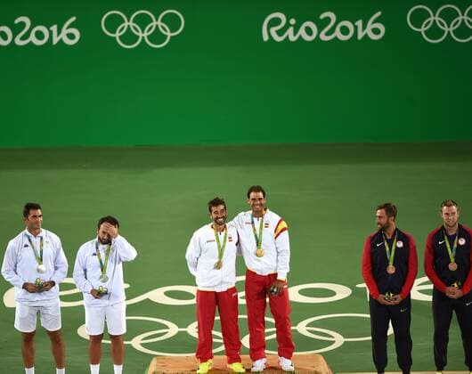 (160812) -- RIO DE JANEIRO, Aug. 12, 2016 -- Rafael Nadal (4th L) and Marc Lopez (3th L) of Spain celebrate at the awarding ceremony of men s doubles tennis at the 2016 Rio Olympic Games Olympische Spiele Olympia OS in Rio de Janeiro, Brazil, on Aug. 12, 2016. Rafael Nadal and Marc Lopez won the gold medal. )(dh) (SP)BRAZIL-RIO DE JANEIRO-OLYMPICS-TENNIS YuexYuewei 