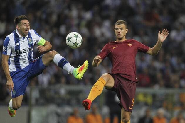 August 17, 2016 - Porto, Porto, Portugal - Porto s Mexican midfielder Hector Herrera (L) with Roma s forward Edin Dzeko (R) during the UEFA Champions League match between FC Porto and AS Roma, at Dragao Stadium in Porto on August 17, 2016. Porto v AS Roma: UEFA Champions League  - ZUMAn230
