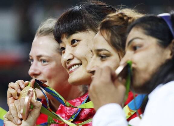 Olympic scenes: Japan judoka Icho wins 4th straight Olympic gold Gold medalist Kaori Icho (2nd from L) of Japan, silver medalist Valeriia Koblova Zholobova (L) of Russia and bronze medalists Marwa Amri (2nd from R) of Tunisia and Sakshi Malik of India pose for a photo during the award ceremony for the women s freestyle wrestling 58-kilogram class at the Rio de Janeiro Olympics on Aug. 17, 2016. Icho became the first female athlete to win four consecutive Olympic gold medals. 