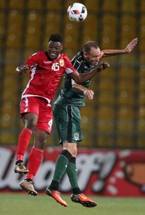 KRASNODAR, RUSSIA - AUGUST 18, 2016: Partizani Tirana s Caleb Ekuban (L) and Krasnodar s Vitaly Kaleshin jump to head the ball in the first leg of their UEFA Europa League play-off tie at Kuban Stadium. Vitaly Timkiv TASS  TS02DAF1