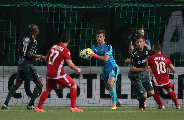 KRASNODAR, RUSSIA - AUGUST 18, 2016: Krasnodar s goalkeeper Stanislav Kritsyuk (C) makes a save as his teammates Charles Kabore (77, left), Fyodor Smolov (9, 2nd R), and Partizani Tirana s Agustin Torassa (27) and Idriz Batha (10) look on in the first leg of their UEFA Europa League play-off tie at Kuban Stadium. Vitaly Timkiv TASS  TS02DAED