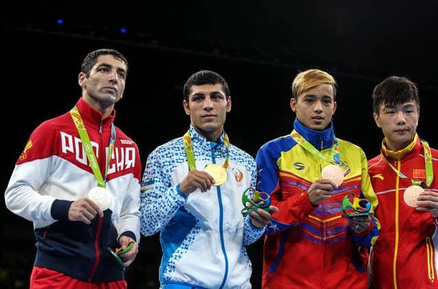 RIO DE JANEIRO, BRAZIL - AUGUST 21, 2016: Silver medallist Mikhail Aloyan of Russia, gold medallist Shakhobidin Zoirov of Uzbekistan, bronze medallists Yoel Segundo Finol of Venezuela and Hu Jiangyan of China (L-R) pose at the victory ceremony for the men s fly 52kg boxing event at the Rio 2016 Summer Olympic Games Olympische Spiele Olympia OS at Riocentro Pavilion 6. Valery Sharifulin TASS  TS02E1F1