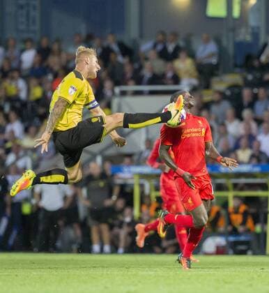 23.08.2016. Pirelli Stadium, Burton on Trent, England. EFL Cup Football. Burton Albion versus Liverpool. Burton Albion& x2019;s Kyle McFadzean with a high kick to clear the ball. xRolandxHarrisonx  ActionPlus11779504