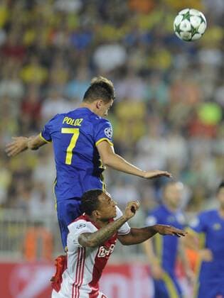 ROSTOV-ON-DON, RUSSIA - AUGUST 24, 2016: Rostov s Dmitry Poloz (blue) and Ajax s Kenny Tete (white) fight for the ball in their 2016 17 UEFA Champions League First playoff round 2nd leg match at Olimp-2 Stadium. FC Rostov won the game 4:1. Valery Matytsin TASS  TS02E7E6