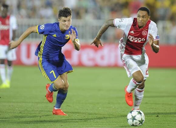 ROSTOV-ON-DON, RUSSIA - AUGUST 24, 2016: Rostov s Dmitry Poloz (L) and Ajax s Kenny Tete fight for the ball in their 2016 17 UEFA Champions League First playoff round 2nd leg match at Olimp-2 Stadium. FC Rostov won the game 4:1. Valery Matytsin TASS  TS02E7E8