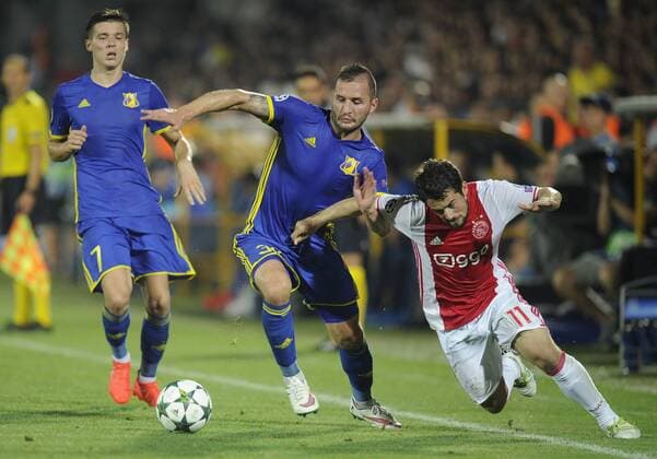 ROSTOV-ON-DON, RUSSIA - AUGUST 24, 2016: Rostov s Dmitry Poloz, Fyodor Kudryashov and Ajax s Amin Younes (L-R) fight for the ball in their 2016 17 UEFA Champions League First playoff round 2nd leg match at Olimp-2 Stadium. FC Rostov won the game 4:1. Valery Matytsin TASS  TS02E80F