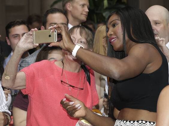 Serena WILLIAMS takes a selfie with fan when Serena Williams, Venus Williams and Rafael Nadal participate in a Virtual Tennis Tournament at Lotte New York Palace on August 25, 2016 in New York City. The US Open Tennis Championships begin on Monday.  NYP20160825107 JOHNxANGELILLO