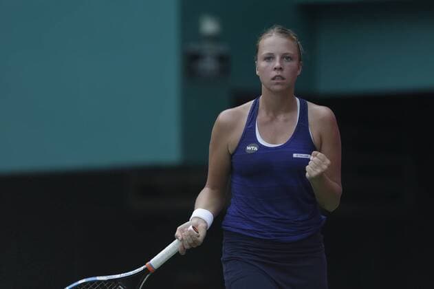 Anett Kontaveit of Estonia reacts after scoring against Viktorija Golubic of Switzerland during their women s singles quarter-final match of the WTA Tennis Damen Guangzhou Open 2016 in Guangzhou city, south China s Guangdong province, 22 September 2016. Anett Kontaveit defeated Viktorija Golubic 2-1. Anett Kontaveit eliminates Viktorija Golubici to advance to semi-final at WTA Guangzhou Open  pbu507770_08