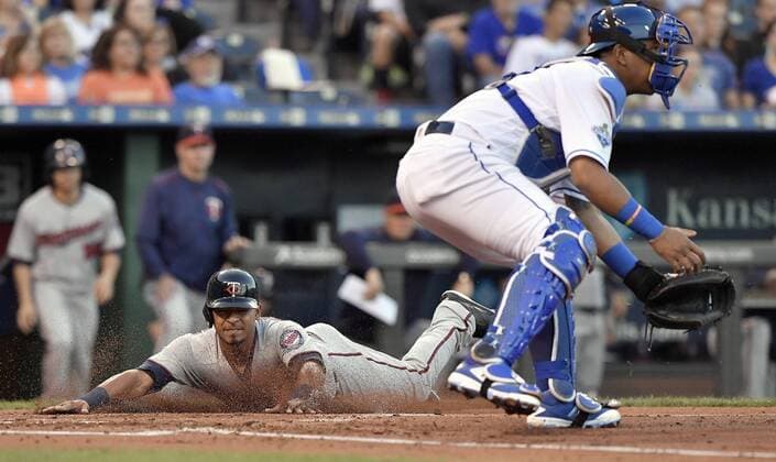 September 27, 2016 - Kansas City, MO, USA - The Minnesota Twins Eduardo Escobar scores behind Kansas City Royals catcher Salvador Perez on a double by Juan Centeno in the second inning on Tuesday, Sept. 27, 2016, Kauffman Stadium in Kansas City, Mo. Minnesota at Kansas City - ZUMAm67_