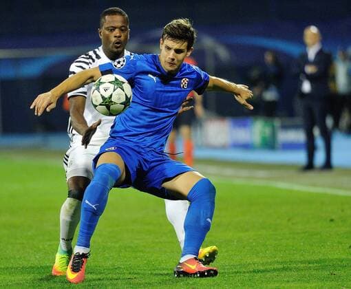(160928) -- ZAGREB, Sept. 27, 2016 -- Patrice Evra of Juventus (back) vies with Mario Situm of Dinamo Zagreb during the UEFA Champions League Group H match between Dinamo Zagreb and Juventus in Zagreb, Croatia, Sept. 27, 2016. Juventus FC won 4-0. ) (SP)CROATIA-ZAGREB-UEFA CHAMPIONS LEAGUE MisoxLisanin 