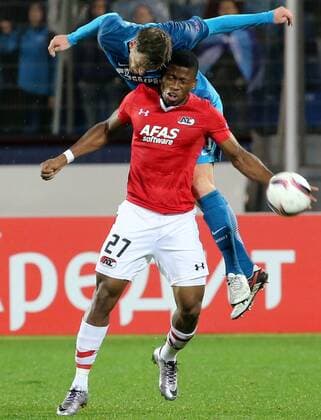 ST PETERSBURG, RUSSIA â€“ SEPTEMBER 29, 2016: AZ Alkmaar s Fred Friday (red) and FC Zenit St Petersburg s Nicolas Lombaerts fight for the ball in their 2016 17 UEFA Europe League Group D Round 2 football match at Petrovsky Stadium. FC Zenit won the game 5-0. Alexander Demianchuk TASS  TS032CED