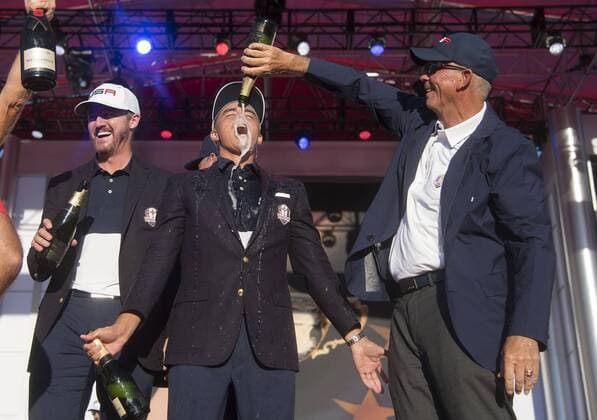 USA team vice captain Tom Lehman pours champions on Rickie Fowler after the United States defeated Europe 17-11 to win the 2016 Ryder Cup at Hazeltine National Golf Club in Chaska, Minnesota on October 2, 2016. USA defeated Europe for the first time since 2008.  MIN20161002340 KEVINxDIETSCH