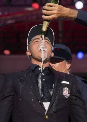 USA team vice captain Tom Lehman pours champions on Rickie Fowler after the United States defeated Europe 17-11 to win the 2016 Ryder Cup at Hazeltine National Golf Club in Chaska, Minnesota on October 2, 2016. USA defeated Europe for the first time since 2008.  MIN20161002344 KEVINxDIETSCH