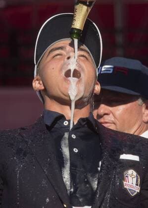 USA team vice captain Tom Lehman pours champions on Rickie Fowler after the United States defeated Europe 17-11 to win the 2016 Ryder Cup at Hazeltine National Golf Club in Chaska, Minnesota on October 2, 2016. USA defeated Europe for the first time since 2008.  MIN20161002345 KEVINxDIETSCH