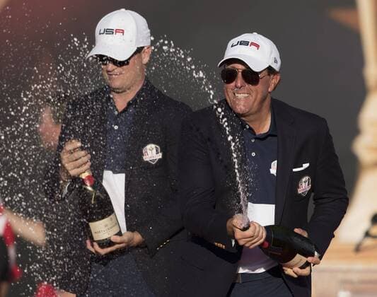 USA team member Phil Mickelson and Zach Johnson celebrates after the United States defeated Europe 17-11 to win the 2016 Ryder Cup at Hazeltine National Golf Club in Chaska, Minnesota on October 2, 2016. USA defeated Europe for the first time since 2008.  MIN20161002348 KEVINxDIETSCH