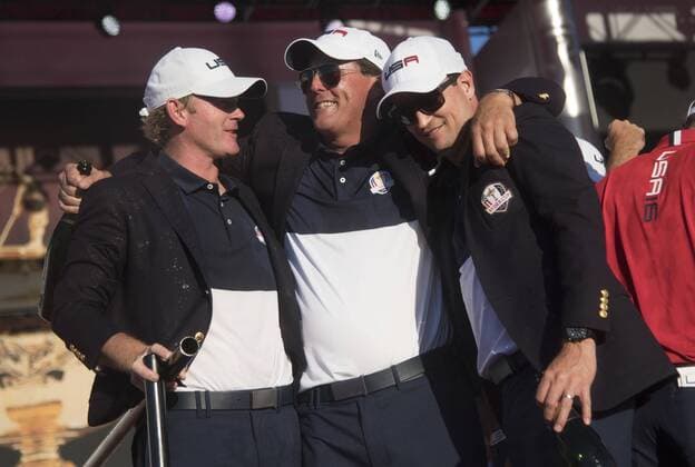 USA team members Brandt Sneaker, Phil Mickelson and Zach Johnson celebrate after the United States defeated Europe 17-11 to win the 2016 Ryder Cup at Hazeltine National Golf Club in Chaska, Minnesota on October 2, 2016. USA defeated Europe for the first time since 2008.  MIN20161002355 KEVINxDIETSCH