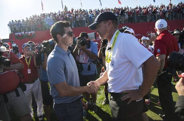 USA team vice-captain Steve Stricker hugs European team member Rory McIlroy after United States defeated Europe 17-11 to win the 2016 Ryder Cup at Hazeltine National Golf Club in Chaska, Minnesota on October 2, 2016. USA defeated Europe for the first time since 2008.  MIN20161002358 KEVINxDIETSCH