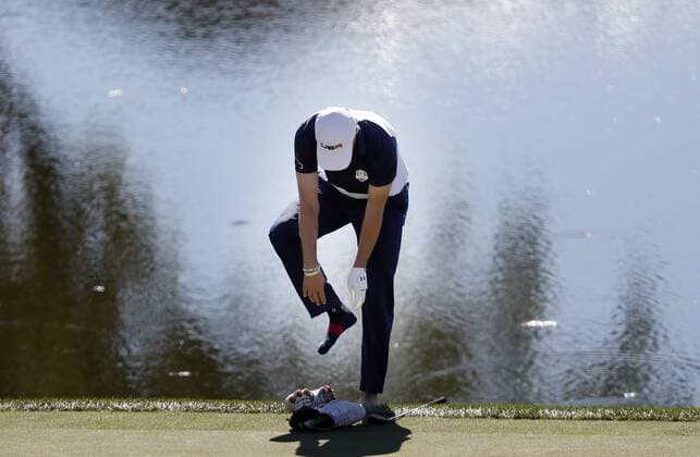 Golf, Ryder Cup 2016 in Chaska October 2, 2016 - Chaska, MN, USA - Jordan Spieth removes his shoes and socks after his ball landed near a water hazard on the 16th hole during the final round of the Ryder Cup on Sunday, Oct. 2, 2016 at the Hazeltine National Golf Club in Chaska, Minn. Ryder Cup staying as United States closes out Europe; first victory since 2008 - ZUMAm67_