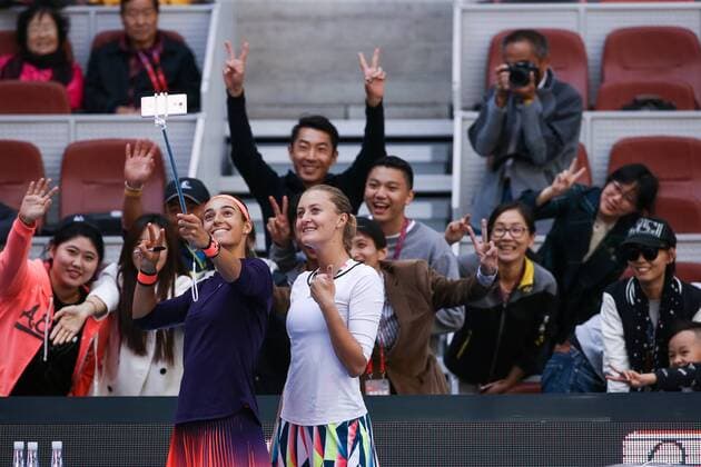 BEIJING, CHINA - OCTOBER 08: Caroline Garcia and Kristina Mladenovic of France take selfies with fans after winning the Women s doubles semifinals against Hao-Ching Chan and Yung-Jan Chan of Chinese Taipei on day eight of the 2016 China Open at the China National Tennis Centre on October 8, 2016 in Beijing, China.  CFP493487110 