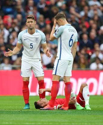 England s Gary Cahill and John Stones look on after Wayne RooneyÕs tackle on Malta s Andre Schembri during the World Cup Qualifying Group F match at Wembley Stadium, London. Picture date October 8th, 2016 Pic David Klein Sportimage EDITORIAL USE ONLY. No use with unauthorised audio, video, data, fixture lists, club league logos or live services. Online in-match use limited to 120 images, no video emulation. No use in betting, games or single club league player publications.