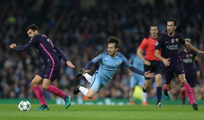 David Silva of Manchester City muscled off the ball by Andre Gomes of Barcelona and Sergio Busquets of Barcelona during the Champions League Group C match at the Etihad Stadium, Manchester. Picture date: November 1st, 2016. Pic Simon Bellis Sportimage EDITORIAL USE ONLY. No use with unauthorised audio, video, data, fixture lists, club league logos or live services. Online in-match use limited to 120 images, no video emulation. No use in betting, games or single club league player publications.