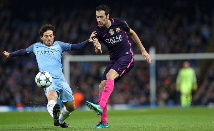 Football - 2016 2017 UEFA Champions League - Group C: Manchester City vs. Barcelona Sergio Aguero of Manchester City closes dow Sergio Busquets of Barcelona during the match at The Etihad Stadium. COLORSPORT LYNNE CAMERON 