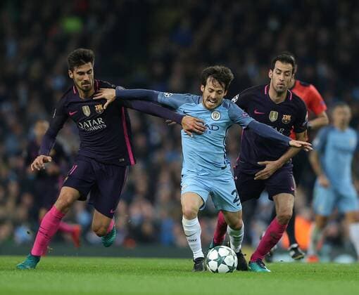 David Silva of Manchester City muscled off the ball by Andre Gomes of Barcelona and Sergio Busquets of Barcelona during the Champions League Group C match at the Etihad Stadium, Manchester. Picture date: November 1st, 2016. Pic Simon Bellis Sportimage EDITORIAL USE ONLY. No use with unauthorised audio, video, data, fixture lists, club league logos or live services. Online in-match use limited to 120 images, no video emulation. No use in betting, games or single club league player publications.