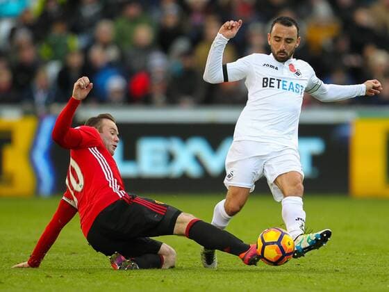 06.11.2016. Liberty Stadium, Swansea, Wales. Premier League Football. Swansea versus Manchester United ManU Swansea City s Leon Britton (captain) and Manchester United s Wayne Rooney (captain) challenge for the ball xPaulxJenkinsx  ActionPlus11807958