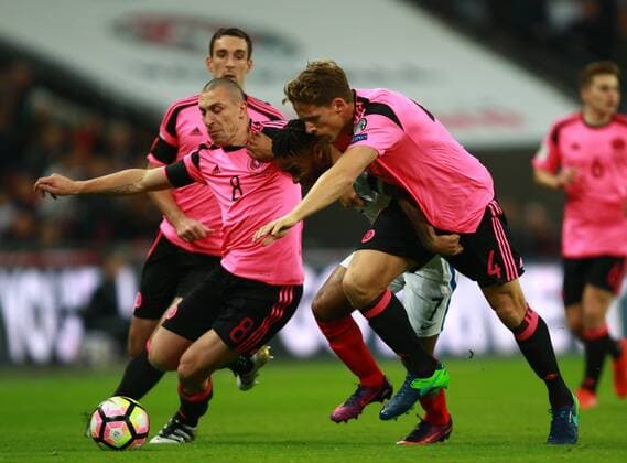 England v Scotland - FIFA World Cup WM Weltmeisterschaft Fussball 2018 Qualifier . . London, UK . . 11.11.2016 Scott Brown (S) Raheem Sterling (E) Christophe Berra (S) 