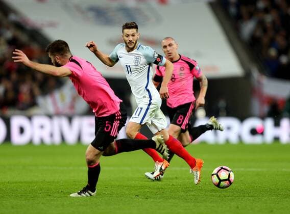 Adam Lallana of England passes the ball behind Grant Hanley of Scotland during the FIFA World Cup WM Weltmeisterschaft Fussball Qualifying Group F match at Wembley Stadium, London. Picture date: November 11th, 2016. Pic David Klein Sportimage EDITORIAL USE ONLY. No use with unauthorised audio, video, data, fixture lists, club league logos or live services. Online in-match use limited to 120 images, no video emulation. No use in betting, games or single club league player publications.