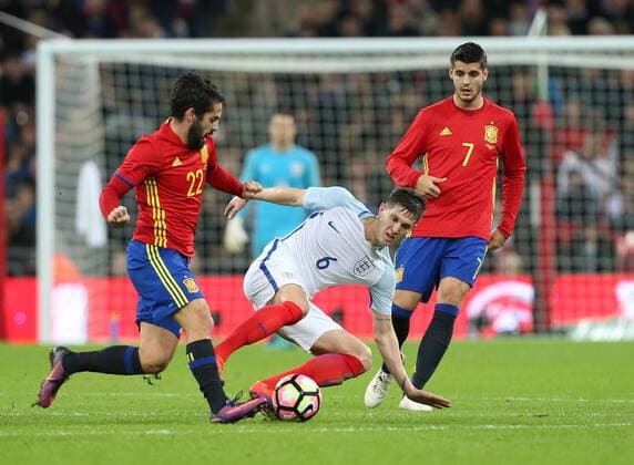 England s John Stones tussles with Spain s Isco during the friendly match at Wembley Stadium, London. Picture date November 15th, 2016 Pic David Klein Sportimage EDITORIAL USE ONLY. No use with unauthorised audio, video, data, fixture lists, club league logos or live services. Online in-match use limited to 120 images, no video emulation. No use in betting, games or single club league player publications.