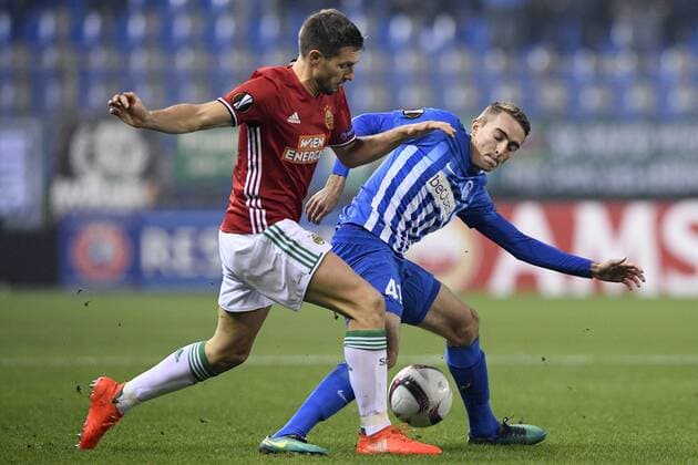 Rapid s Thomas Schrammel and Genk s Timothy Castagne fight for the ball during a game of the fifth day of the group stage (Group F) of the Europa League competition between Belgian soccer team RC Genk and Austrian team Rapid Wien, Thursday 24 November 2016, in Genk. YORICKxJANSENS  x04982775x