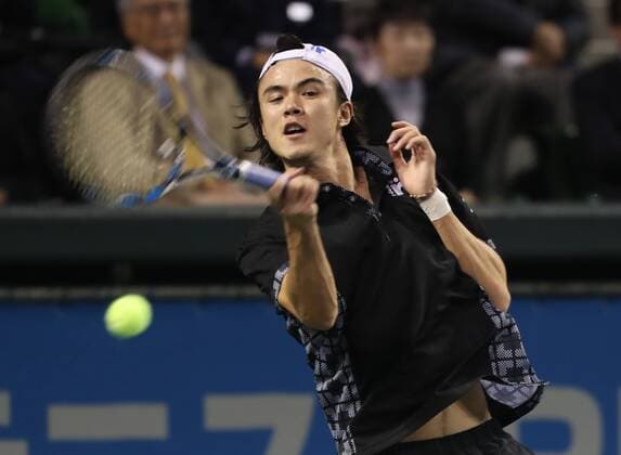 November 26, 2016, Tokyo, Japan - Japan s Taro Daniel returns the ball against former French Opens Tennis champion Michael Chang of the United States during an annual charity tennis match Dream Tennis Ariake in Tokyo on Saturday, November 26, 2016. Admission money will be donated for the rebuild of tennis facilities at the tsunami affected area in northern Japan. NOxTHIRDxPARTYxSALES.  (lwxa006489)