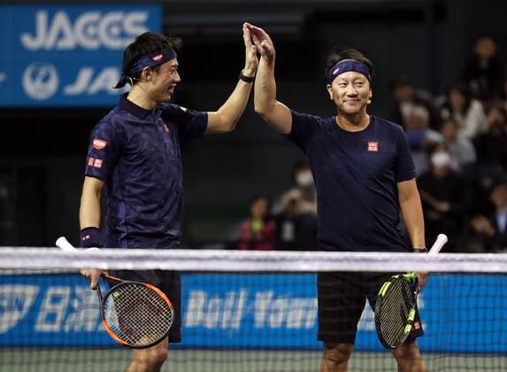 November 26, 2016, Tokyo, Japan - Japan s Kei Nishikori and his coach former French Opens Tennis champion Michael Chang of the United States pair celebrrate their victory against Andy Roddick of the United States and Japan s Taro Daniel during an annual charity tennis match Dream Tennis Ariake in Tokyo on Saturday, November 26, 2016. Admission money will be donated for the rebuild of tennis facilities at the tsunami affected area in northern Japan. NOxTHIRDxPARTYxSALES.  (lwxa006496)