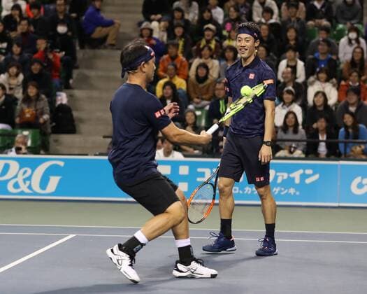 November 26, 2016, Tokyo, Japan - Japan s Kei Nishikori and his coach former French Opens Tennis champion Michael Chang of the United States pair return the ball against Andy Roddick of the United States and Japan s Taro Daniel during an annual charity tennis match Dream Tennis Ariake in Tokyo on Saturday, November 26, 2016. Admission money will be donated for the rebuild of tennis facilities at the tsunami affected area in northern Japan. NOxTHIRDxPARTYxSALES.  (lwxa006497)