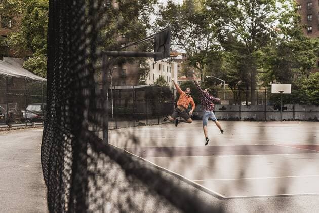 Two young men playing basketball on an outdoor court model released Symbolfoto  UUF09132