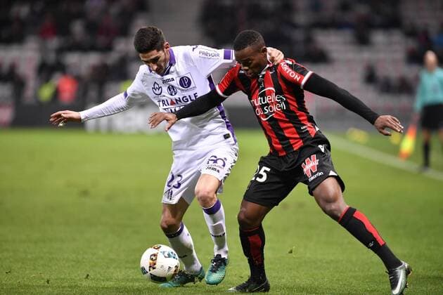 NICE, Dec. 4, 2016 -- Nice s Wylan Cyprien (L) vies with Toulouse s Yann Bodger during the French L1 football match in Nice, France, Dec. 4, 2016. Nice won 3-0. ) (SP)FRANCE-NICE-FRENCH LIGUE 1-NICE VS TOULOUSE ChenxYichen 