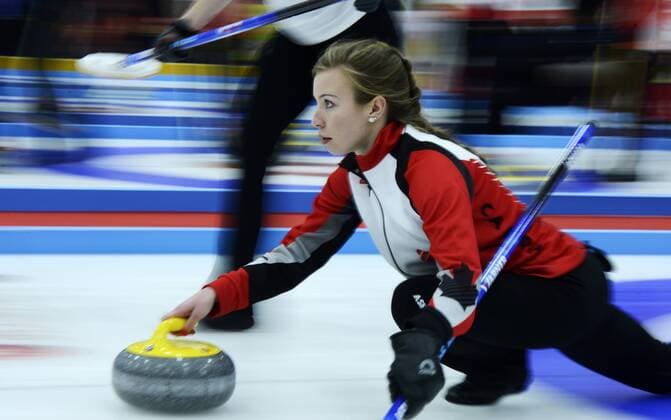 (161212) -- XINING, Dec. 12, 2016 -- Dezaray Hawes of Canada delivers a shot during the China Qinghai international curling competition between Canada and Germany in Xining, capital of northwest China s Qinghai Province, Dec. 11, 2016. Canada lost 5-8.) (hcs) (SP)CHINA-QINGHAI-XINING-CURLING COMPETITION(CN) ZhangxHongxiang 