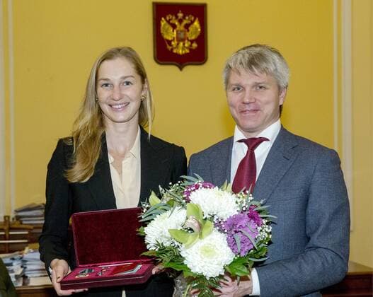 MOSCOW, RUSSIA - DECEMBER 26, 2016: Russian tennis player Ekaterina Makarova (L) and Russia s Sports Minister Pavel Kolobkov at an award ceremony at the offices of the Russian Sports Ministry. Russian tennis players Elena Vesnina and Ekaterina Makarova are awarded for their victory in the women s doubles tennis event at the 2016 Summer Olympic Games Olympische Spiele Olympia OS in Rio de Janeiro, Brazil. Vladimir Gerdo TASS  TS03CC9B