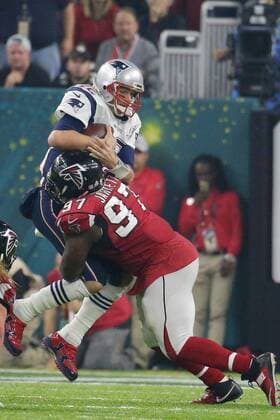 New England Patriots quarterback Tom Brady (12) is sacked by Atlanta Falcons defensive tackle Grady Jarrett (97) in the fourth quarter of Super Bowl LI at NRG Stadium in Houston Texas on February 5, 2017.  SBP20170205750 JOHNxANGELILLO