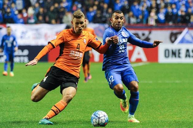 Argentine football player Carlos Tevez of China s Shanghai Greenland Shenhua F.C., right, challenges Daniel Bowles of Australia s Brisbane Roar F.C. in a qualifying match during the 2017 AFC Champions League in Shanghai, China, 8 February 2017. Carlos Tevez s debut for big-spending Chinese Super League side Shanghai Shenhua did not go as planned. In fact, it was the exact opposite as they were unceremoniously dumped out of the Asian Champions League play-off by Brisbane Road. Tevez, who moved to China from Boca Juniors for a reported ¡ê615,000-a-week and became the world s highest-paid player , couldn t help his new team-mates as they went down 2-0 in one of the biggest shocks the AFC has seen. Carlos Tevez has nightmare debut for Shanghai Shenhua as they are dumped out of AFC Champions League  20170208_65741