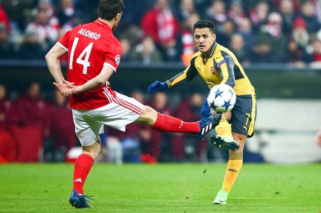 SOCCER - CL, Bayern vs Arsenal MUNICH,GERMANY,15.FEB.17 - SOCCER - UEFA Champions League, FC Bayern Muenchen vs FC Arsenal. Image shows Alexis Sanchez (Arsenal) and Xabi Alonso (Bayern). GEPAxpictures xFelixxRoittner